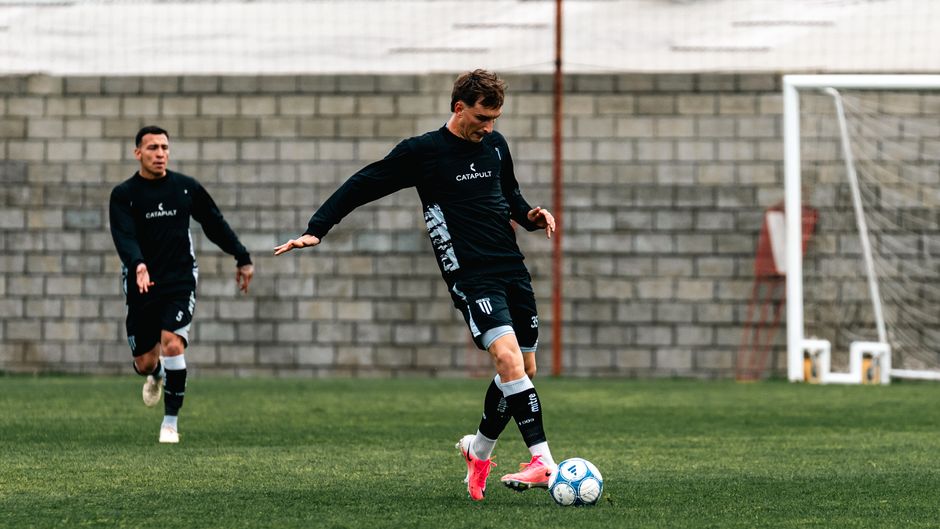 Soccer players in action during a practice session, showcasing agility and coordination.